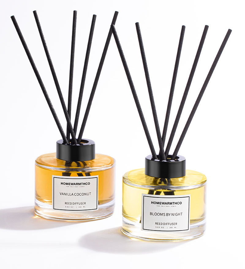 Two reed diffusers from HomewarmthCo on a light background