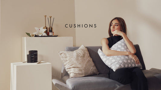 Cozy autumn bedroom with soft cotton bed linen, eco-friendly sheets, a fall room spray bottle on a wooden table, lit candle glowing warmly, scattered autumn leaves and pumpkins, soft natural lighting, calming aromatherapy vibe, high-quality lifestyle