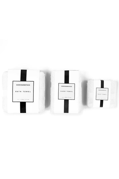 Two white bath towels with black stripes and labels on a white background