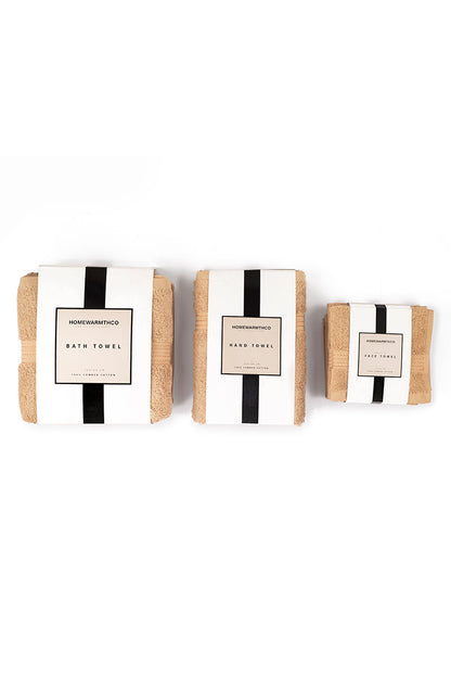 Three bath towels with striped labels on a white background