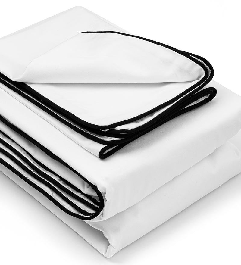 White bed sheets with black edges on a white background