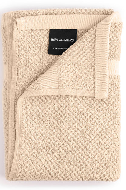 Beige textured blanket with a visible brand label on a white background