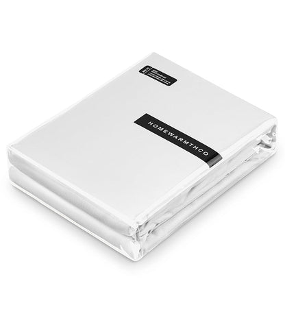 Folded white fitted sheet with 'Homewarmth' label on a white background