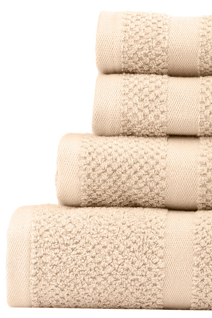 Stack of beige towels with textured surface on a white background