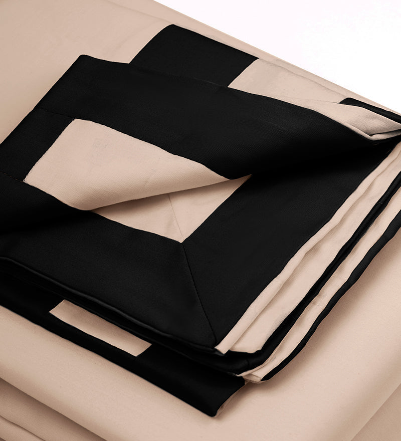 Black and beige fabric with a geometric pattern on a neutral background