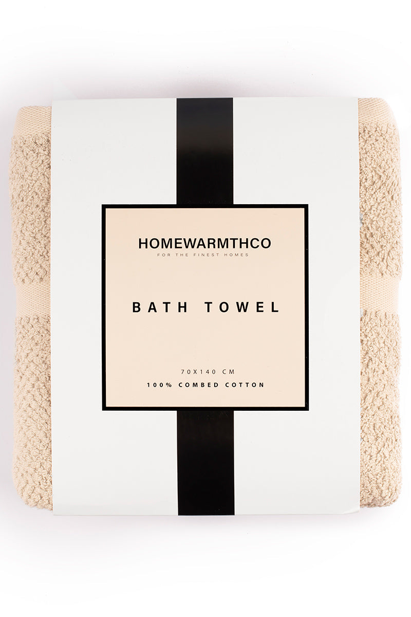 Packaged bath towel with 'Homewarmthco' branding on a white background