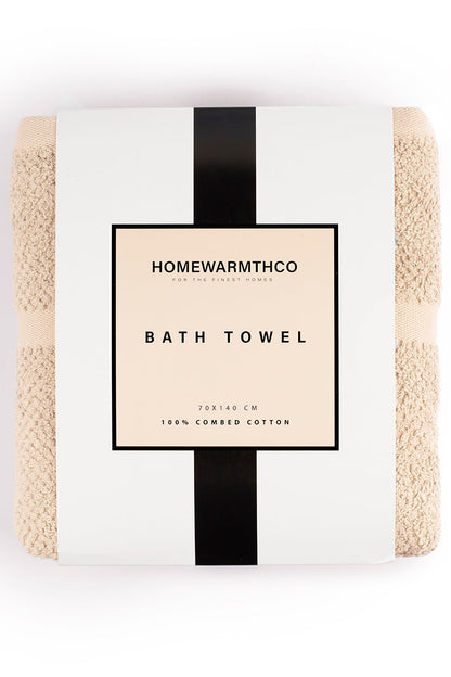 Packaged bath towel with 'Homewarmthco' branding on a white background