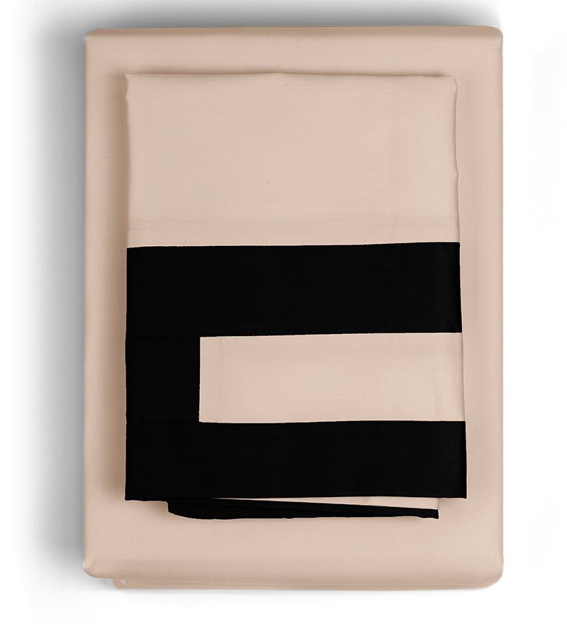 Folded beige blanket with black stripes on a white background