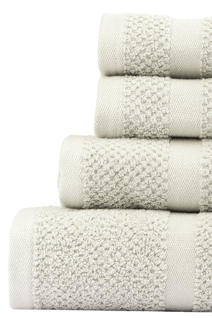 Stack of white textured towels on a white background