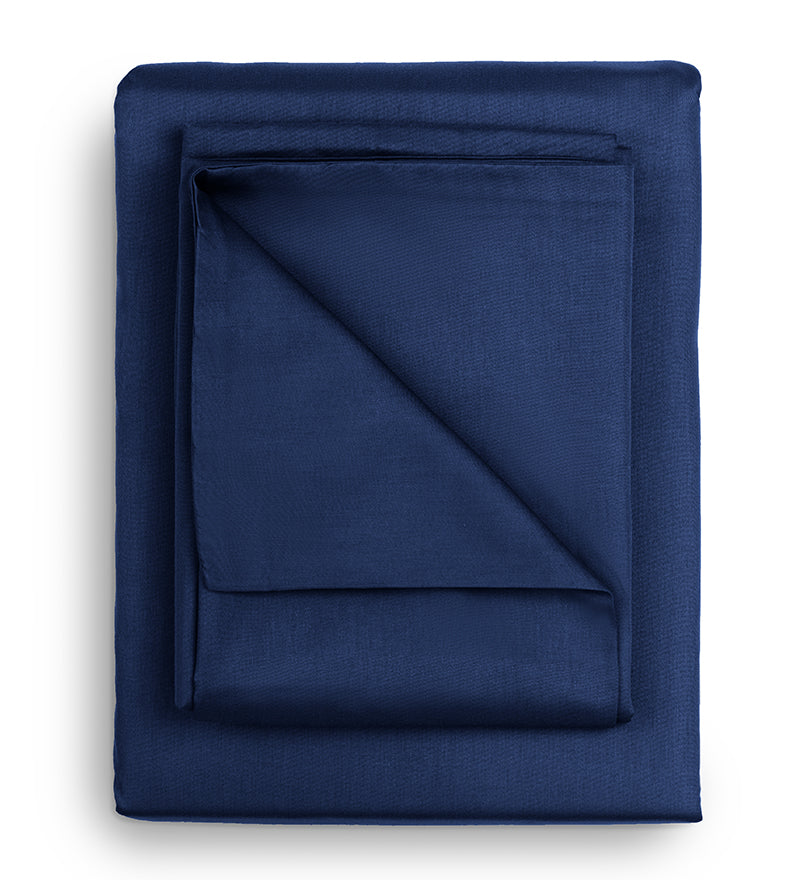 Folded navy blue fabric on a white background