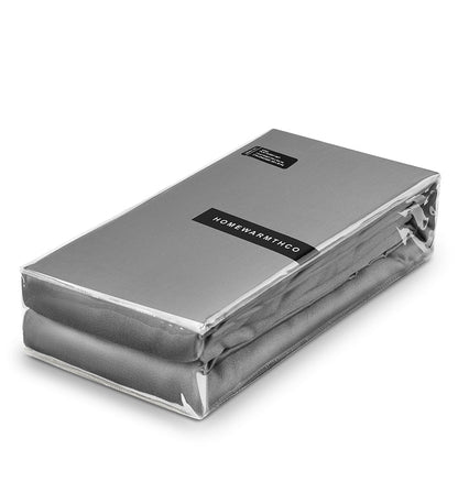 Silver mattress cover with 'HOMEWARMTHCO' label on a white background