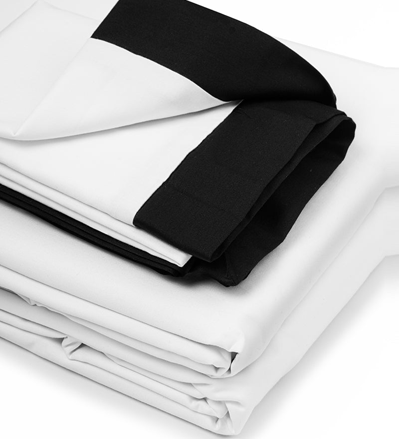 White bed sheets with black border on a white background