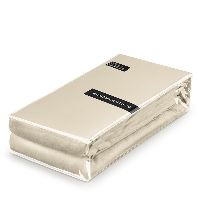 Beige folded blanket with a visible brand label on a white background