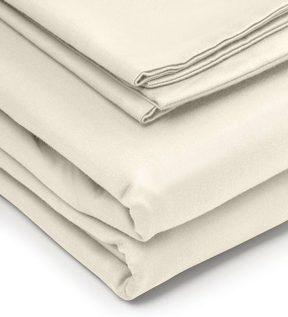 Folded beige bed sheets on a white background