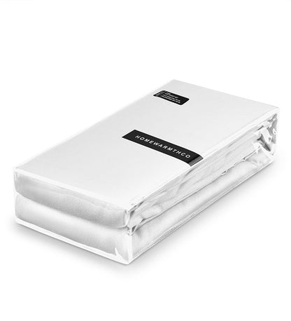 White fitted sheet with a visible brand label on a white background