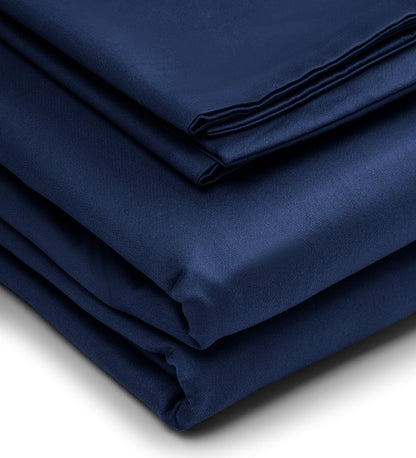 Stack of folded navy blue fabric on a white background