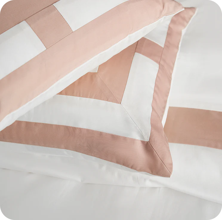 Close-up of pink and white striped bedding on a white background