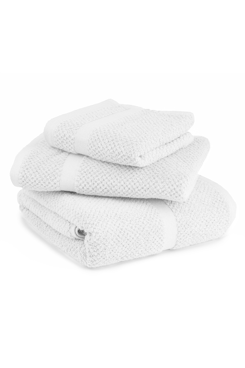 Stack of textured white towels on a white background
