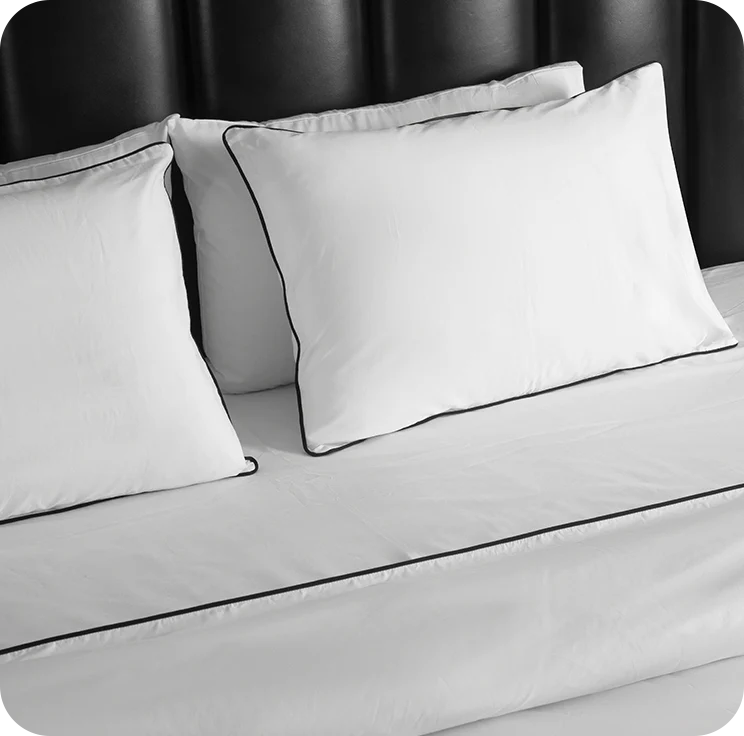 Gray bedding set with pillows on a bed