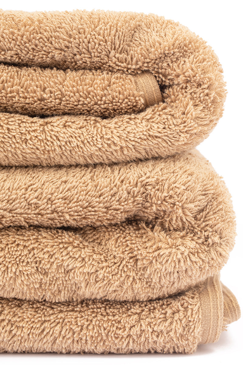 Stack of beige towels on a white background