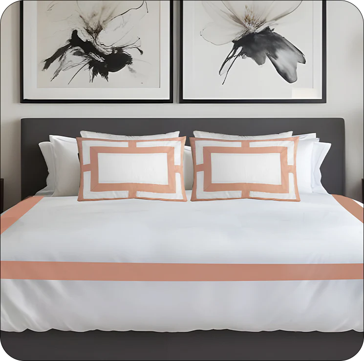 Bedroom with white bedding, peach-colored trim, and abstract art on the wall.