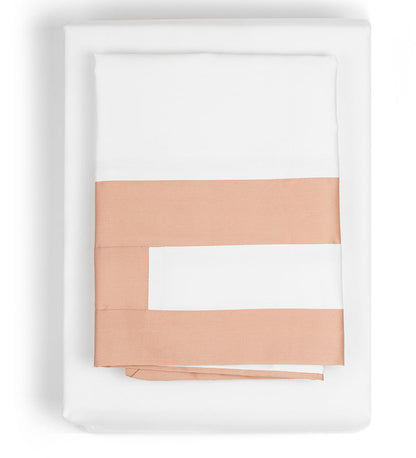 Set of peach-colored folded towels on a white background
