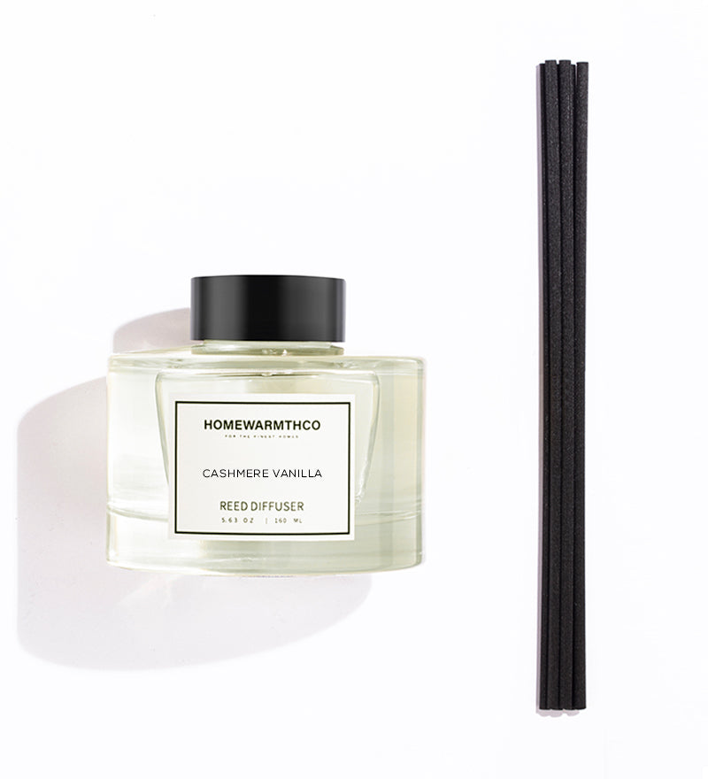 Homewarmthco Cashmere Vanilla reed diffuser with black cap and three black reeds on a white background
