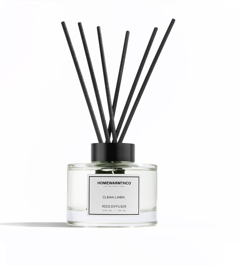 Homewarmthco CLEAN LINEN REED DIFFUSER with black sticks on a white background