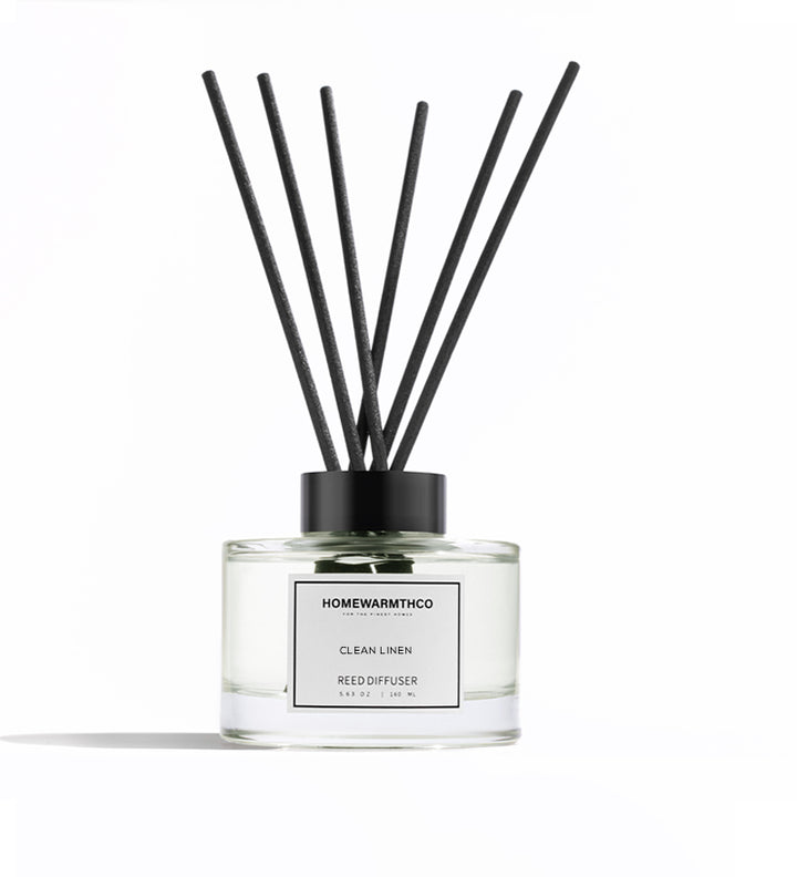 Homewarmthco CLEAN LINEN REED DIFFUSER with black sticks on a white background