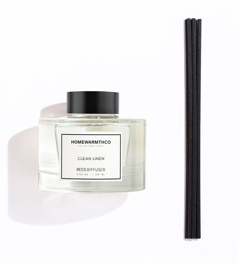 Homewarmthco CLEAN LINEN REED DIFFUSER with black sticks on a white background