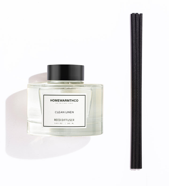 Homewarmthco CLEAN LINEN REED DIFFUSER with black sticks on a white background