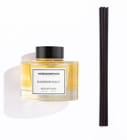 Homewarmthco reed diffuser with black cap and white label on a white background