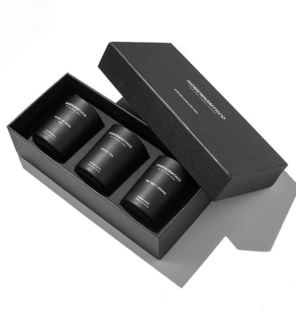 Three black candles in a box with 'Noma' branding on a white background