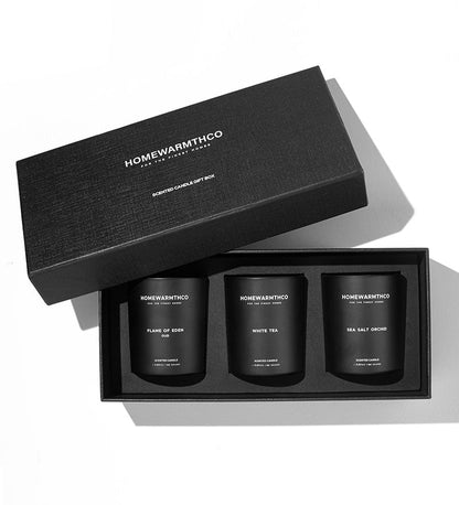 Set of three black candles in a 'Homewarmthco' gift box on a white background