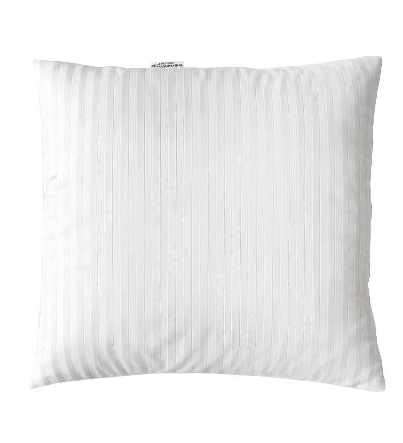 White pillow with a subtle pattern on a white background