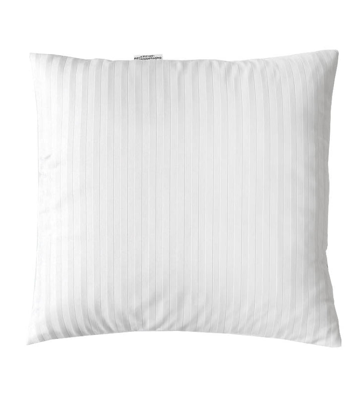 White pillow with a subtle pattern on a white background