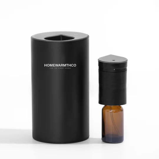 Black electric diffuser with a brown bottle labeled 'HOMEWARMTHCO' on a white background