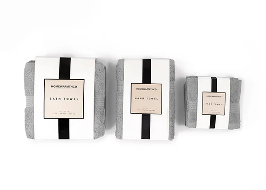 Three folded towels with labels on a white background