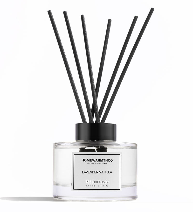 Homewarmthco lavender vanilla reed diffuser with black sticks on a white background
