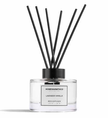 Homewarmthco lavender vanilla reed diffuser with black sticks on a white background