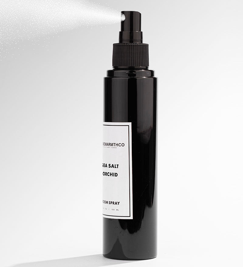 Black spray bottle with a label on a white background