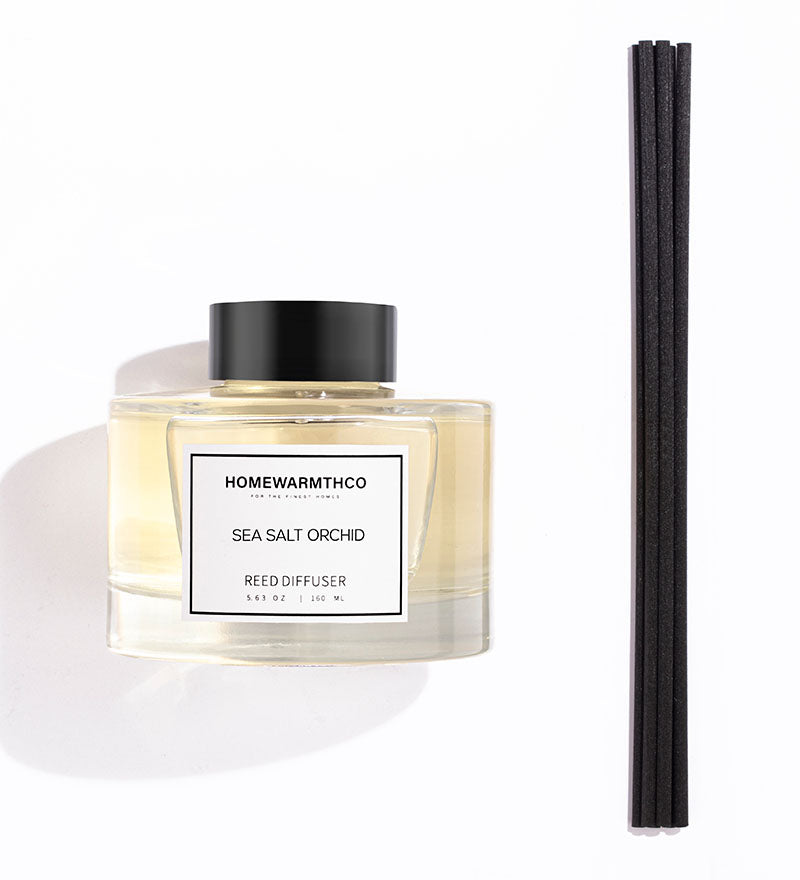 Homewarmthco Sea Salt Orchid reed diffuser with black sticks on a white background