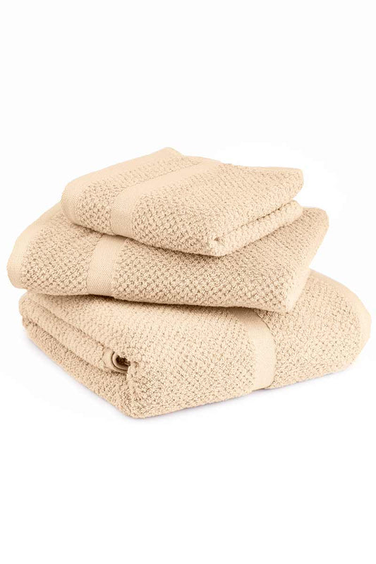 Stack of beige towels on a white background