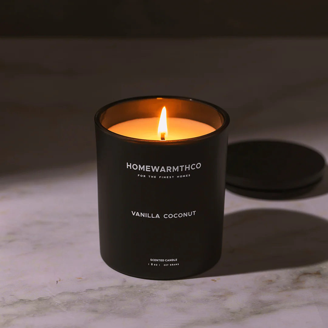 Homewarmthco vanilla coconut candle on a marble surface