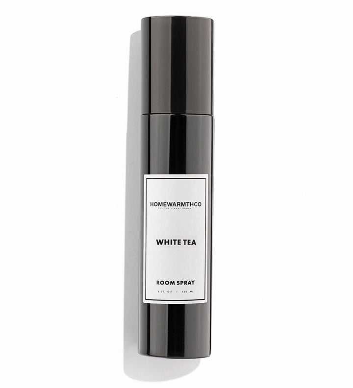 Room spray bottle labeled 'White Tea' by Homewarmthco on a white background