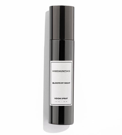 Black room spray bottle with a white label on a white background