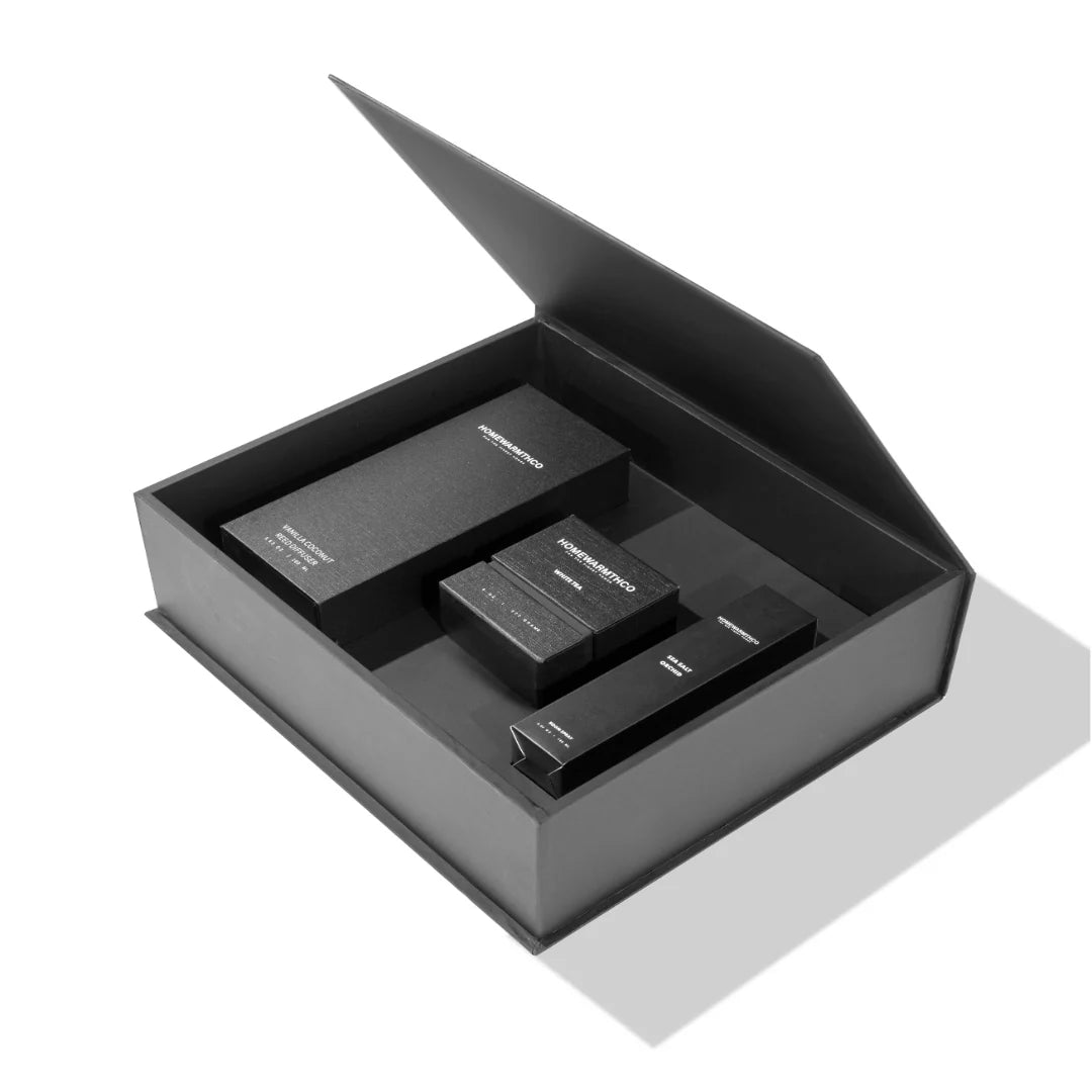 Black cosmetic set with a mirror in an open black gift box on a white background