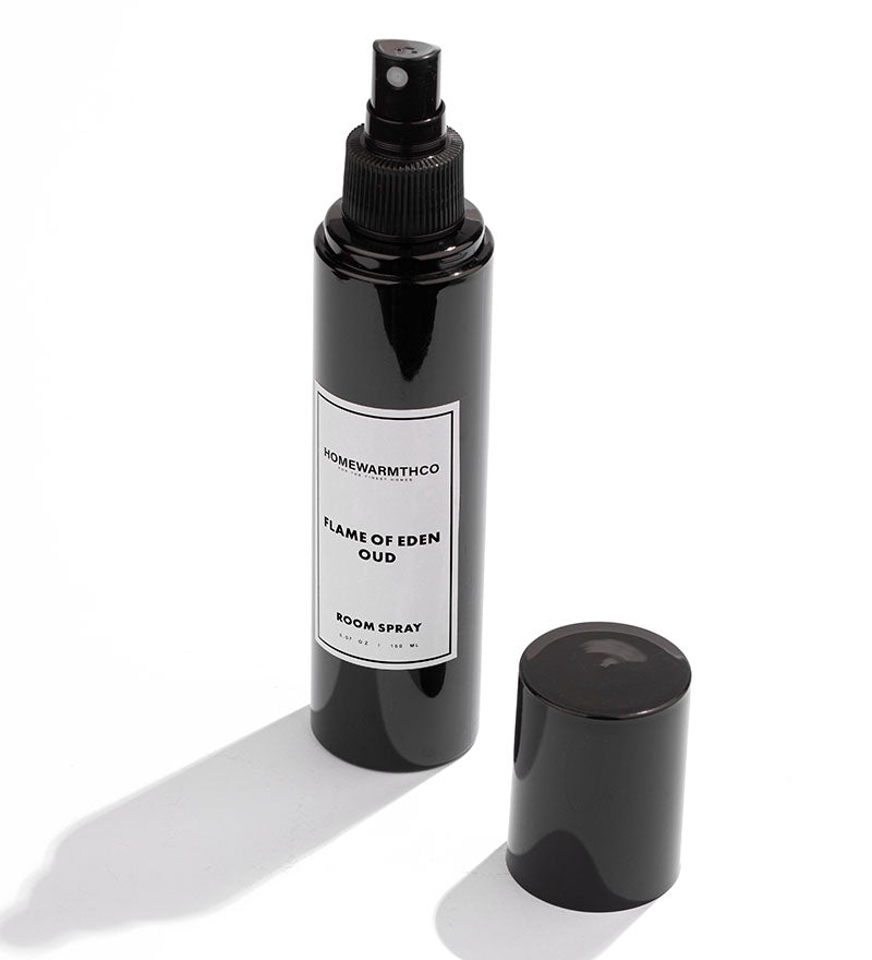 Black room spray bottle labeled 'Flame of Eden Oud' by HomeWarmthCo on a white background