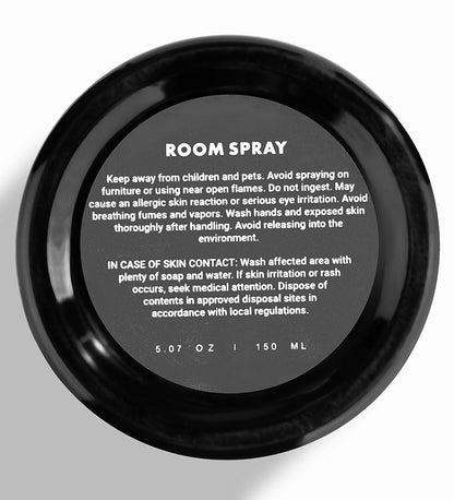 Black room spray container with safety instructions on a white background