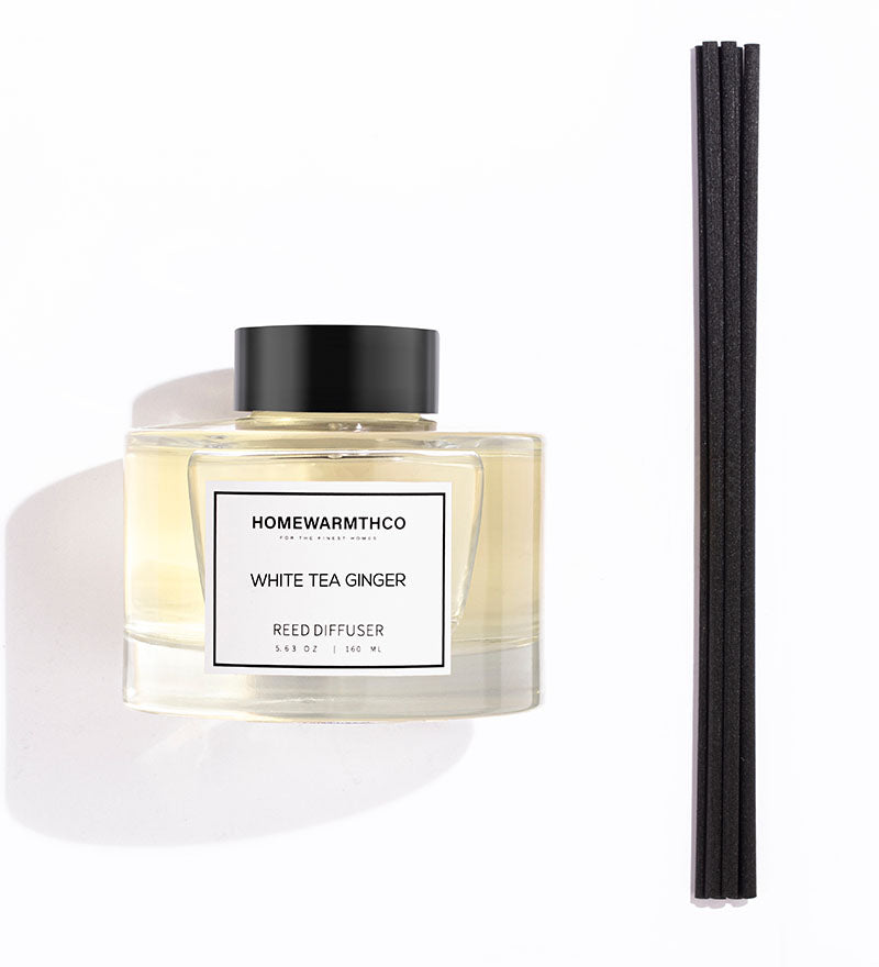 Homewarmthco White Tea Ginger reed diffuser with black sticks on a white background